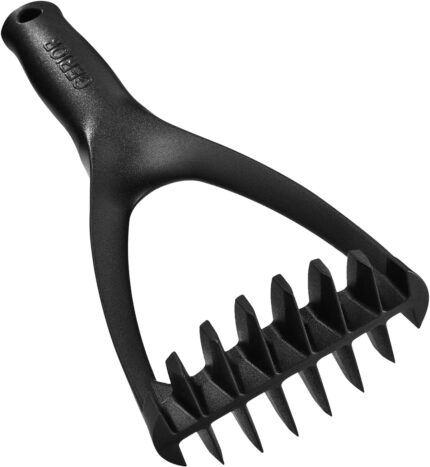 Black nylon potato masher with an ergonomic handle, resting on a white background, showcasing its non-scratch design.