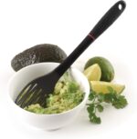 Black 11-inch Grip-EZ Fiskie, a combination fork and whisk utensil, shown in a kitchen setting.