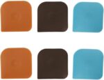 A set of six square nylon pan scrapers in black, red, and brown colors, displayed neatly for kitchen cleaning.