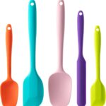 A set of five multicolor silicone spatulas with stainless steel cores, arranged for a kitchen product display.