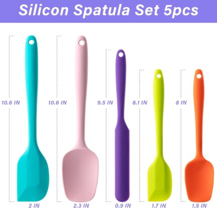 A set of five multicolor silicone spatulas with stainless steel cores, arranged for a kitchen product display.