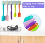 A set of five multicolor silicone spatulas with stainless steel cores, arranged for a kitchen product display.