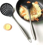 A modern Honglida silicone wok skimmer with a black head and stainless steel handle, resting in a nonstick pan.