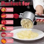 A red Minteem 15oz potato ricer made of stainless steel, shown with its silicone handle, ready for mashing.