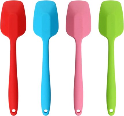 A set of four MOACC multicolor silicone spatulas with rubber and stainless steel handles, arranged neatly on a clean surface.