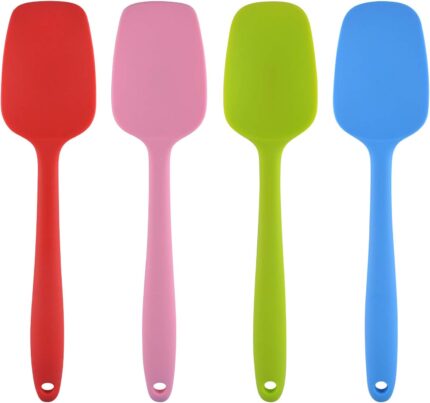 A set of four MOACC multicolor silicone spatulas with rubber and stainless steel handles, arranged neatly on a clean surface.