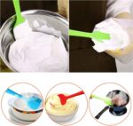 A set of four MOACC multicolor silicone spatulas with rubber and stainless steel handles, arranged neatly on a clean surface.