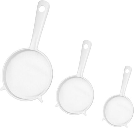 Three white plastic fine mesh strainers with handles, nested together, against a plain background.